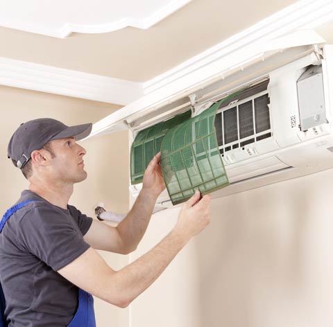 An AC filter being replaced in a ductless unit.