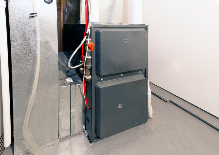 An electric furnace installed in a basement.