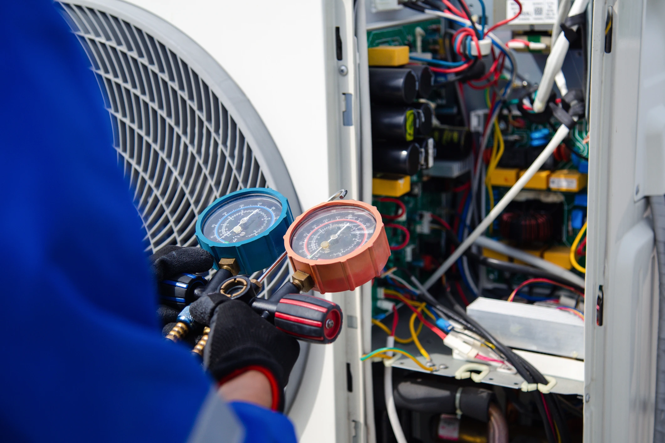 A technician performing maintenance on an AC system.
