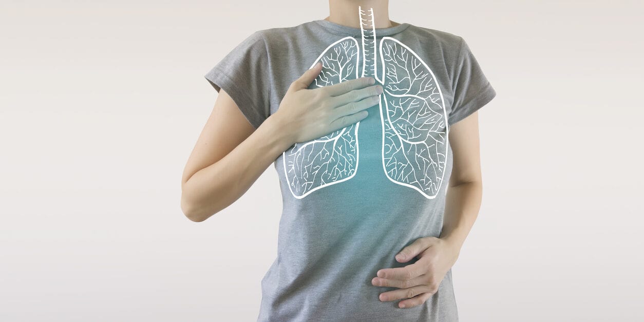 A person breathing deeply with an illustration of the lungs shown.