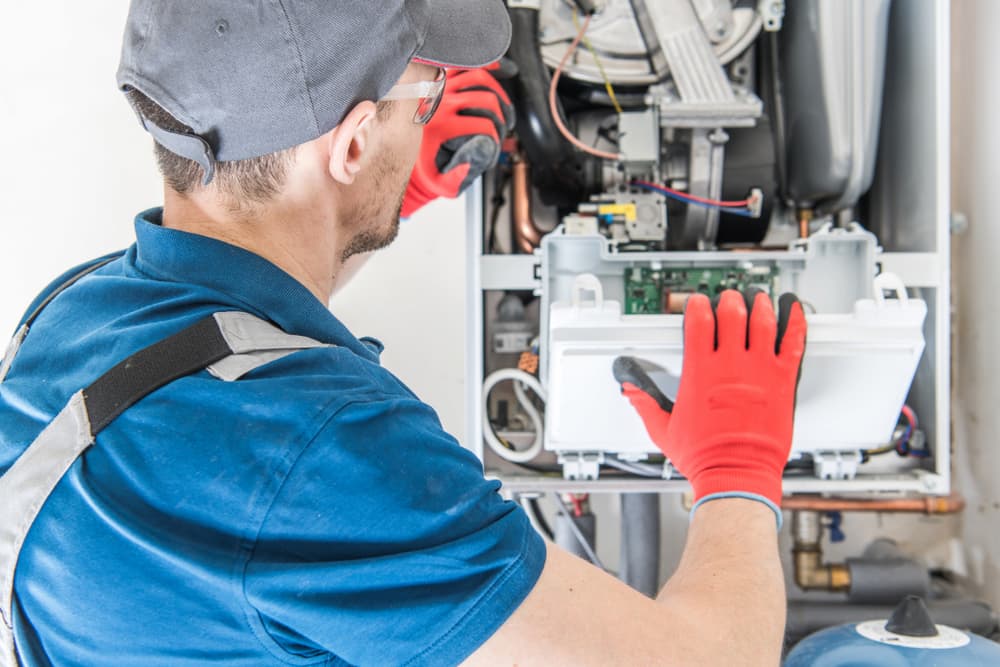 A technician repairing a furnace.