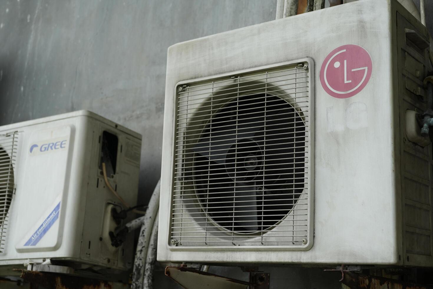 Old and dirty GREE and LG external AC units.