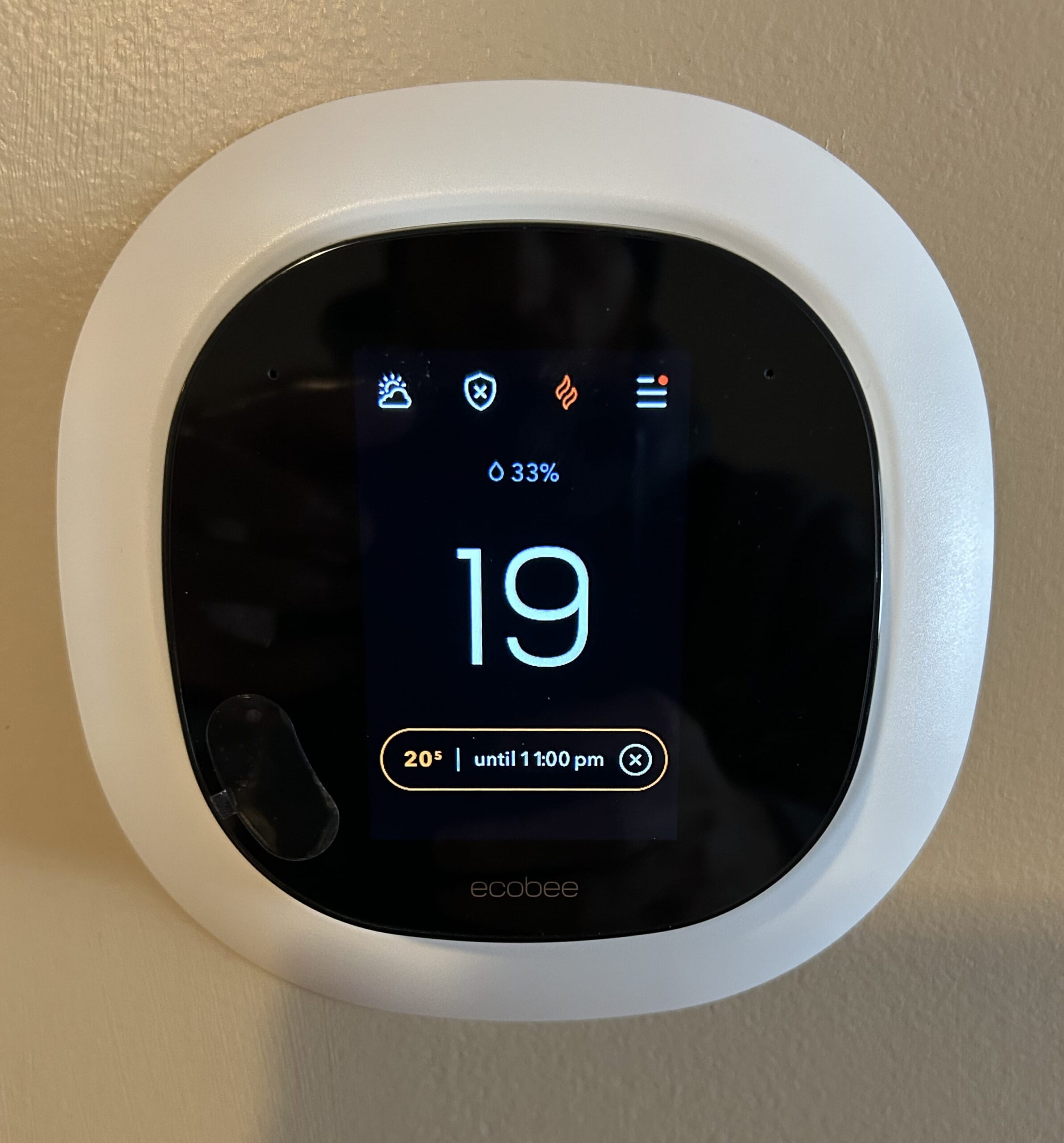 Wall-mounted Ecobee thermostat.