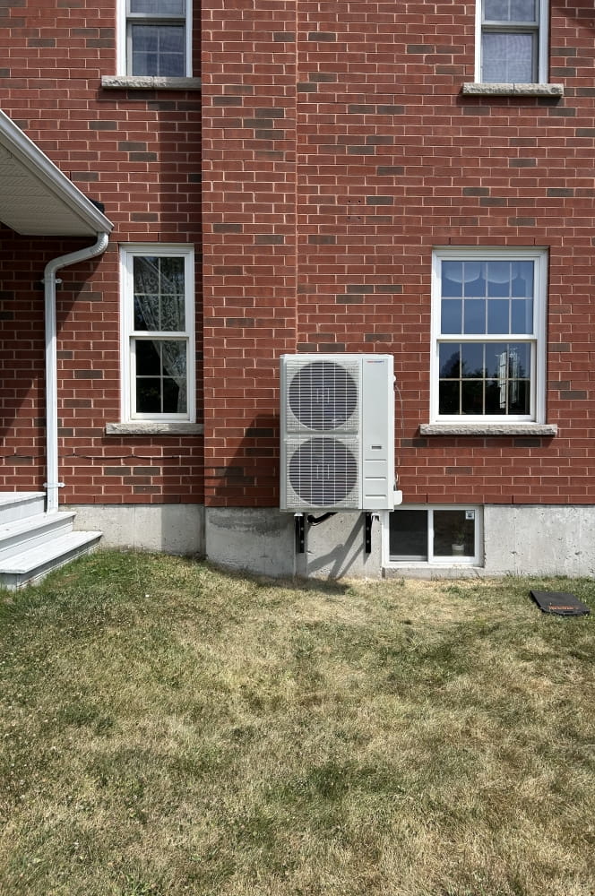 TempShift outdoor unit on wall brackets at a larger home.