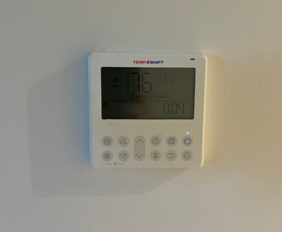 TempShift wall control, thermostat on white wall.