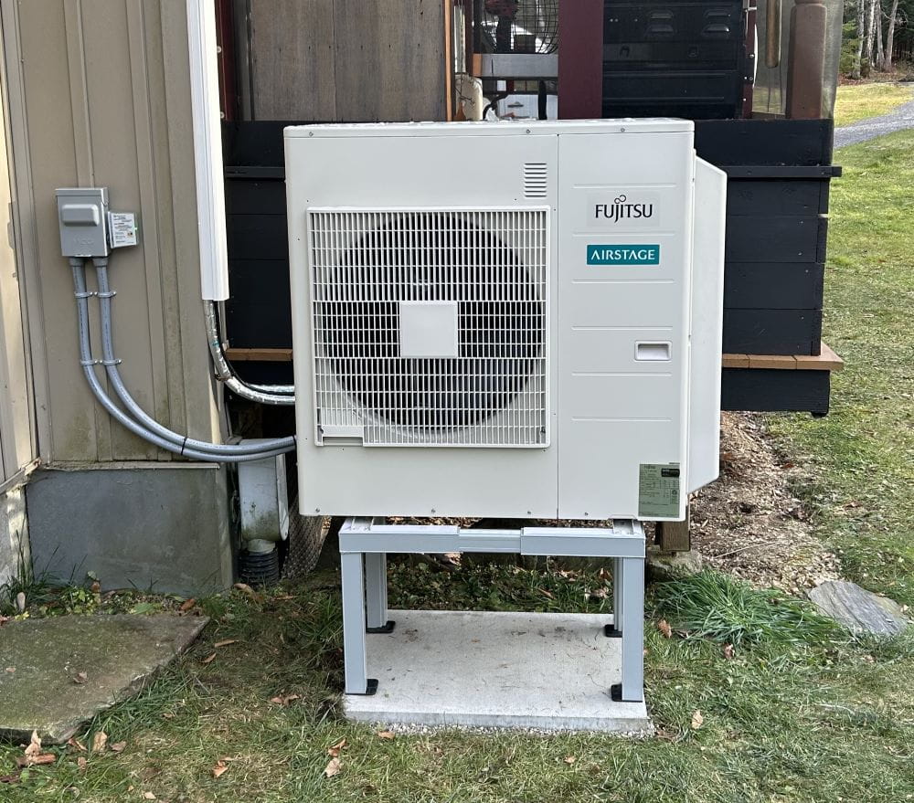 Fujitsu ductless outdoor unit on a snow stand.